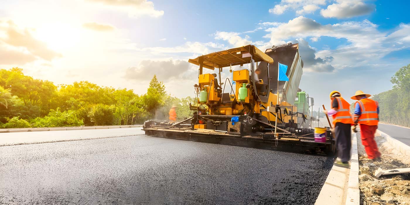 asphalt paver on road bridge construction